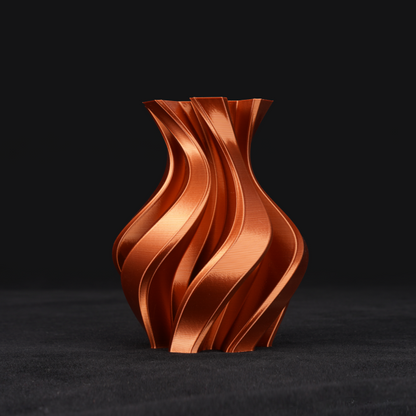 A custom 3D printed vase with a metallic copper finish, featuring a unique spiral design.